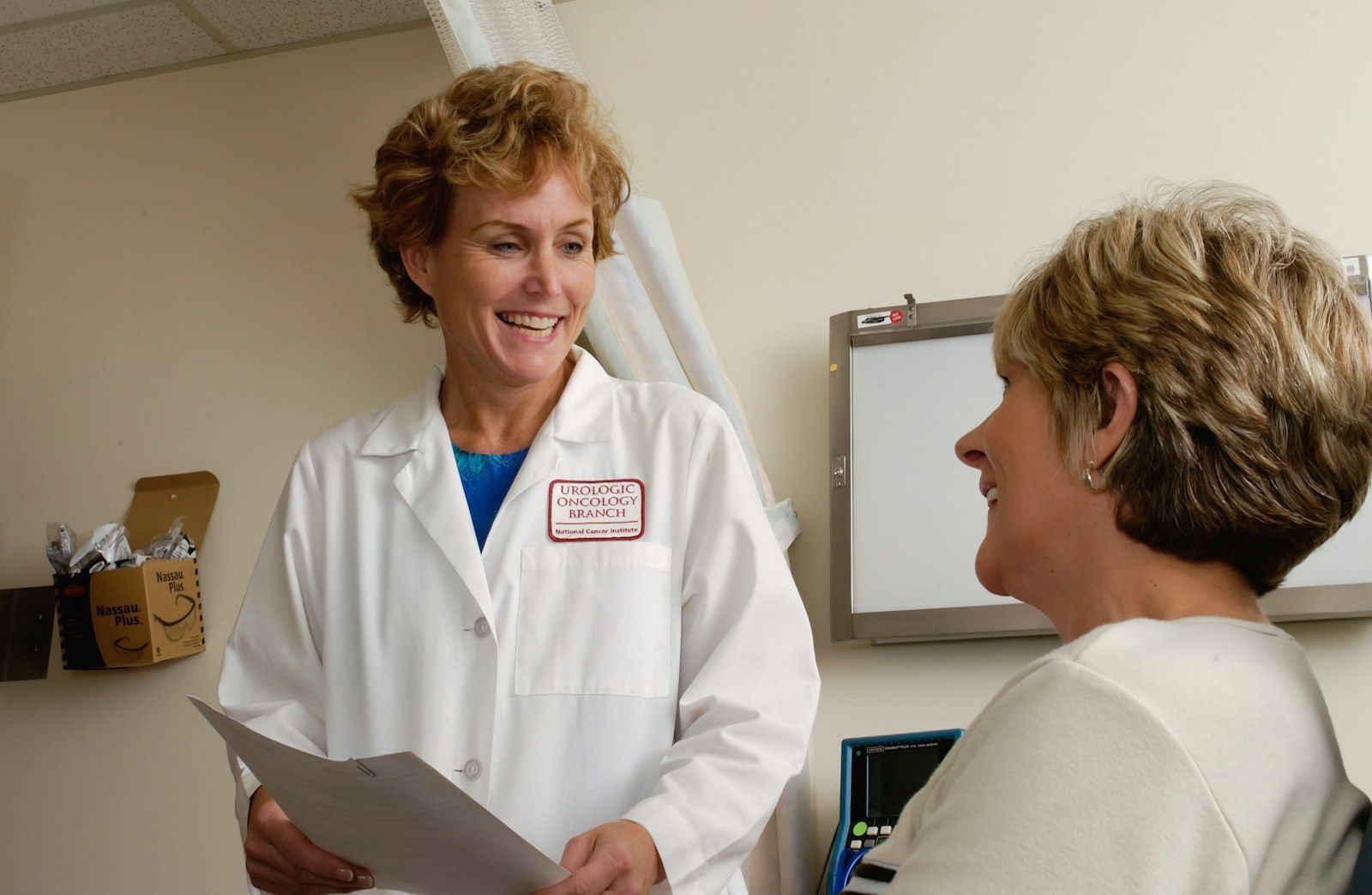 A doctor going over paperwork with a patient in a bright clinic